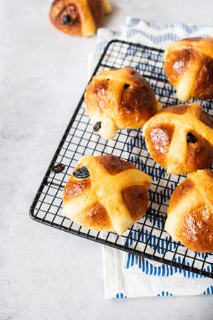 Hot cross buns on a cooling rack, overhead view. Easter baking.