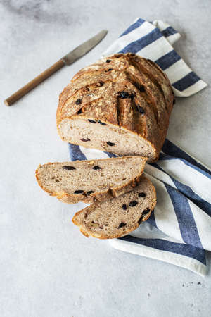 Sliced sourdough bread with raisins and rye flour. Healthy home baking and artisanal bread concept. Top view.の写真素材