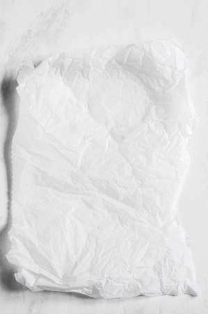 White empty crumpled baking paper background. top view.の写真素材