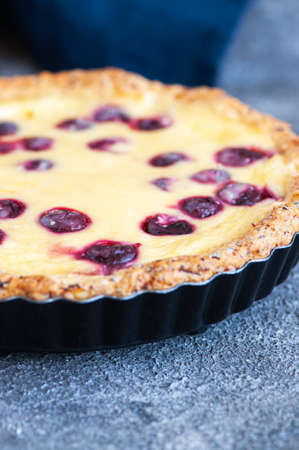 Homemade ricotta cheese pie with cherries on a gray background. close up. Heart baking.の写真素材