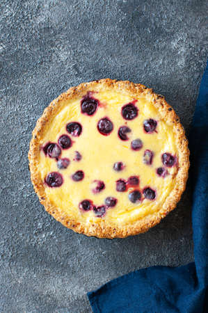 Homemade ricotta cheese pie with cherries on a gray background. top view. Heart baking.の写真素材
