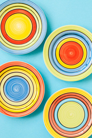 Set of colorful plates on blue background. top view.の写真素材