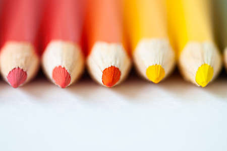 Set of wooden colored pencils- crayons on a white paper.の写真素材