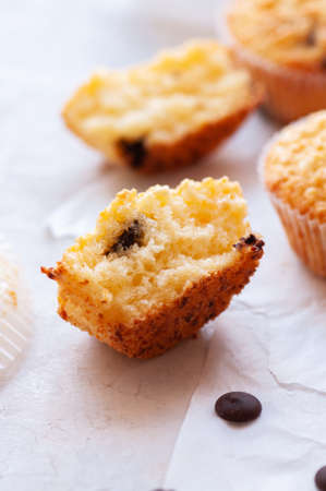 Halved of homemade easy muffins with chocolate chips on a baking paper.の写真素材