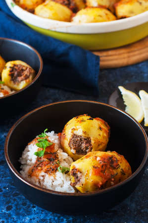 Baked potato stuffed with mince meat and rice with salad. Popular middle eastern food - batata mahshi.の写真素材