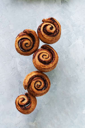 Group of homemade cinnamon buns. Flying food on a gray background. top view.の写真素材