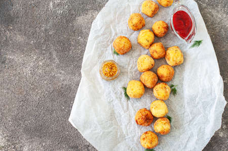 Deep fried potato cheese balls and ketchup. gray background. overhead view. copyspace.の写真素材