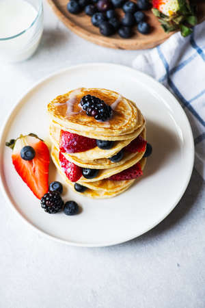 Vanilla pancakes with fruits and berries. Overhead view.の写真素材