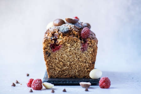 Easter cake with chocolates and raspberry. sliced. Close up.