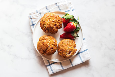 Strawberry muffins served in a plate on a marble background. Top view.の写真素材