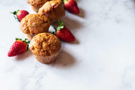 Blueberry muffins served on a white plate on a marble background.の写真素材