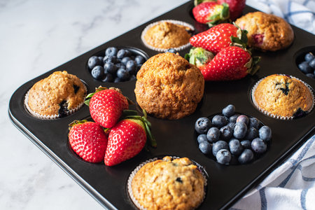 Blueberry muffins served on a white plate on a marble background.の写真素材