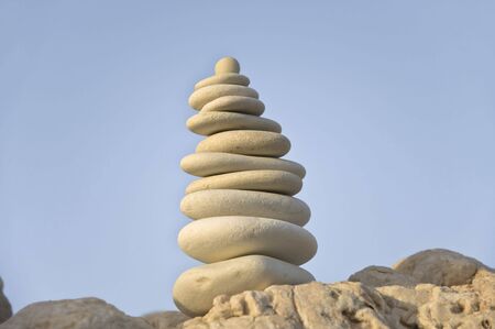 pyramid of white stones on sky background