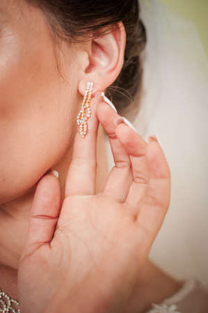 bride wearing earring on the earの写真素材