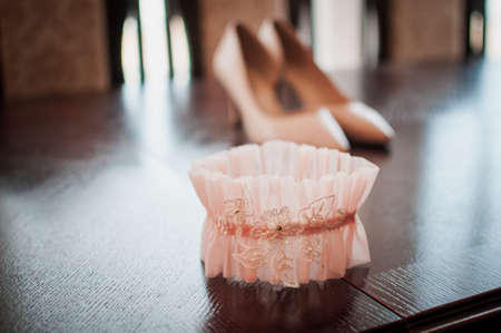 Peach color garter lying on the wooden tableの写真素材