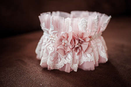 Peach color garter lying on the wooden table