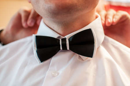 Black and white tiebow on the grooms neckの写真素材
