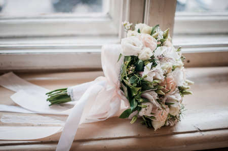 Colorfull wedding bouquet lies on the windowsillの写真素材