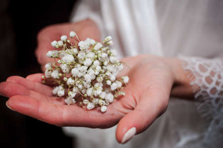 White bouquet of flowers in the girls handの写真素材