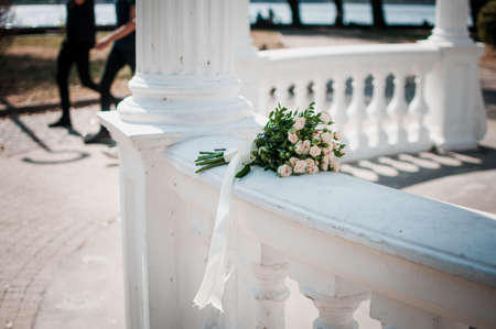 Gold wedding rings on the pink bouquet of flowersの写真素材
