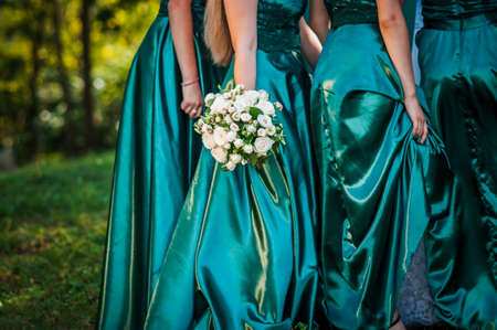 Bouquet of flowers in the hand of bridesmaidの写真素材