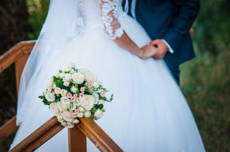 Bouquet of flowers near groom and brideの写真素材
