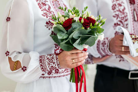 bride holding colorfull wedding bouquet in the handの写真素材