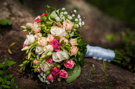 Flower composition, wedding bouquet with ribbon, boutonniere and two golden ringsの写真素材