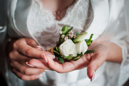 A small bouquet of flowers in the hand of the bride