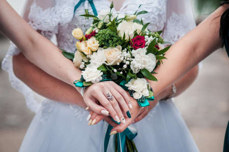 Bouquet of flowers in the hands of the girlsの写真素材