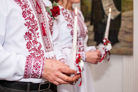 Man and woman holding candle in the hand