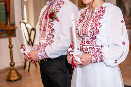 Man and woman holding candle in the hand