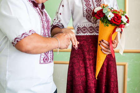 Groom puts on the wedding ring on the finger of the brideの写真素材