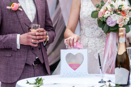 Bride and groom pouring sand in the boxの写真素材