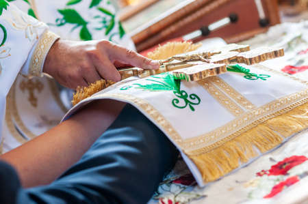 Groom and bride holding hands on the bibleの写真素材