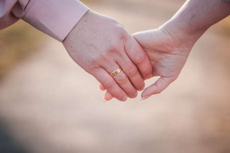 Man and woman holding handsの写真素材