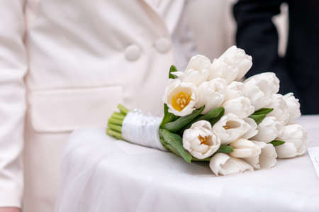 White bouquet of tulips on the white tableの写真素材