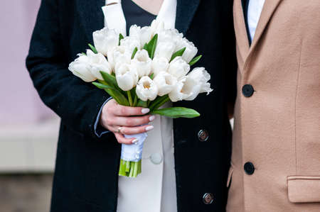 White wedding bouquet in the hands of brideの写真素材