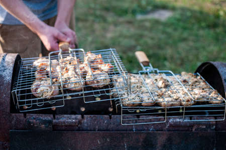 cooking raw meat in a grid on the barbeque grillの写真素材