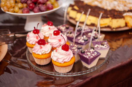 White sweet cupcakes on the white standの写真素材