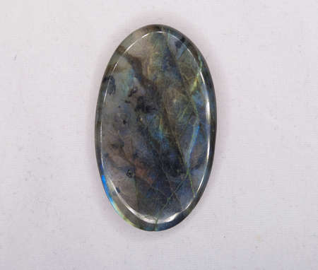 Natural oval labradorite gem on the white backgroundの写真素材
