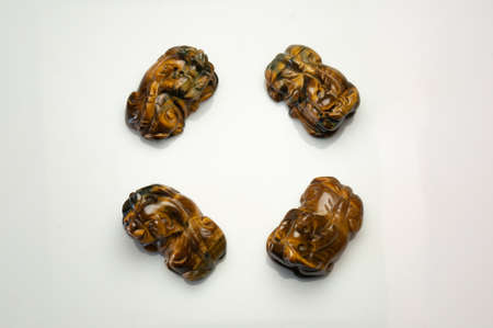 Natural tiger eye pet carving on the white background