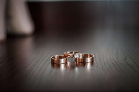 Pair of gold wedding rings and gold ring with gem