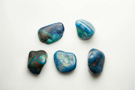 Blue shattuckite cabochon on the white background