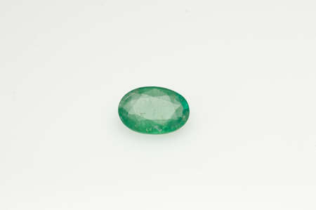 Natural green emerald oval shape on the white backgroundの写真素材