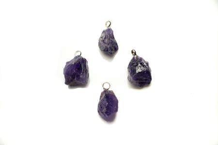 Natural violet amethyst rough pendant on the white backgroundの写真素材