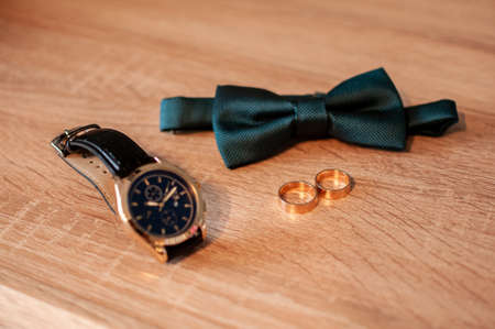 bow tie and pair of gold wedding ringsの写真素材