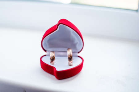 Pair of gold wedding rings in the red boxの写真素材