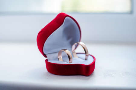 Pair of gold wedding rings in the red boxの写真素材