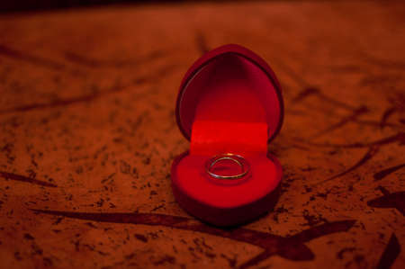 Gold wedding ring in the dark red boxの写真素材
